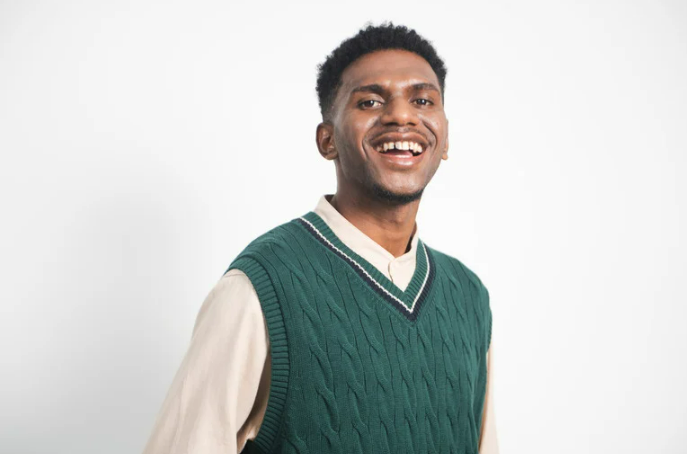 Young professional wearing a green shirt, smiling
